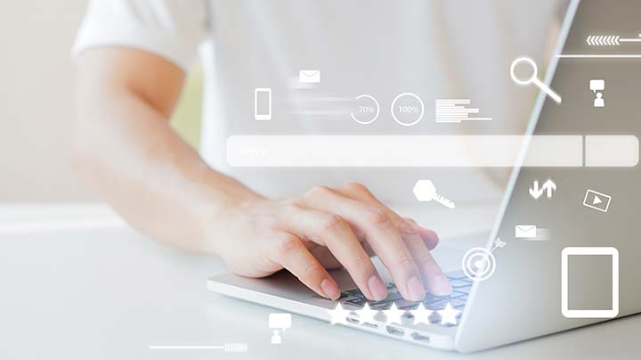 A person typing on a laptop
