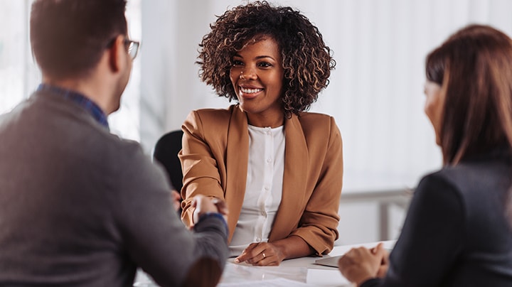 Three people having a conversation about a project