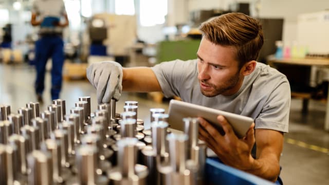A Man inspecting products in factory