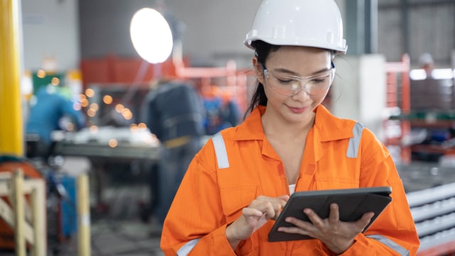 A women taking a notes in a factory